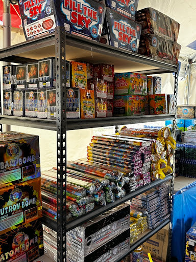 Shelves stocked with various firework boxes labeled 'Fill the Sky' and other types of fireworks.